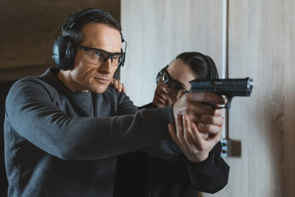 female instructor describing client how to shoot in shooting range e1635265506461 1 3617723.jpg